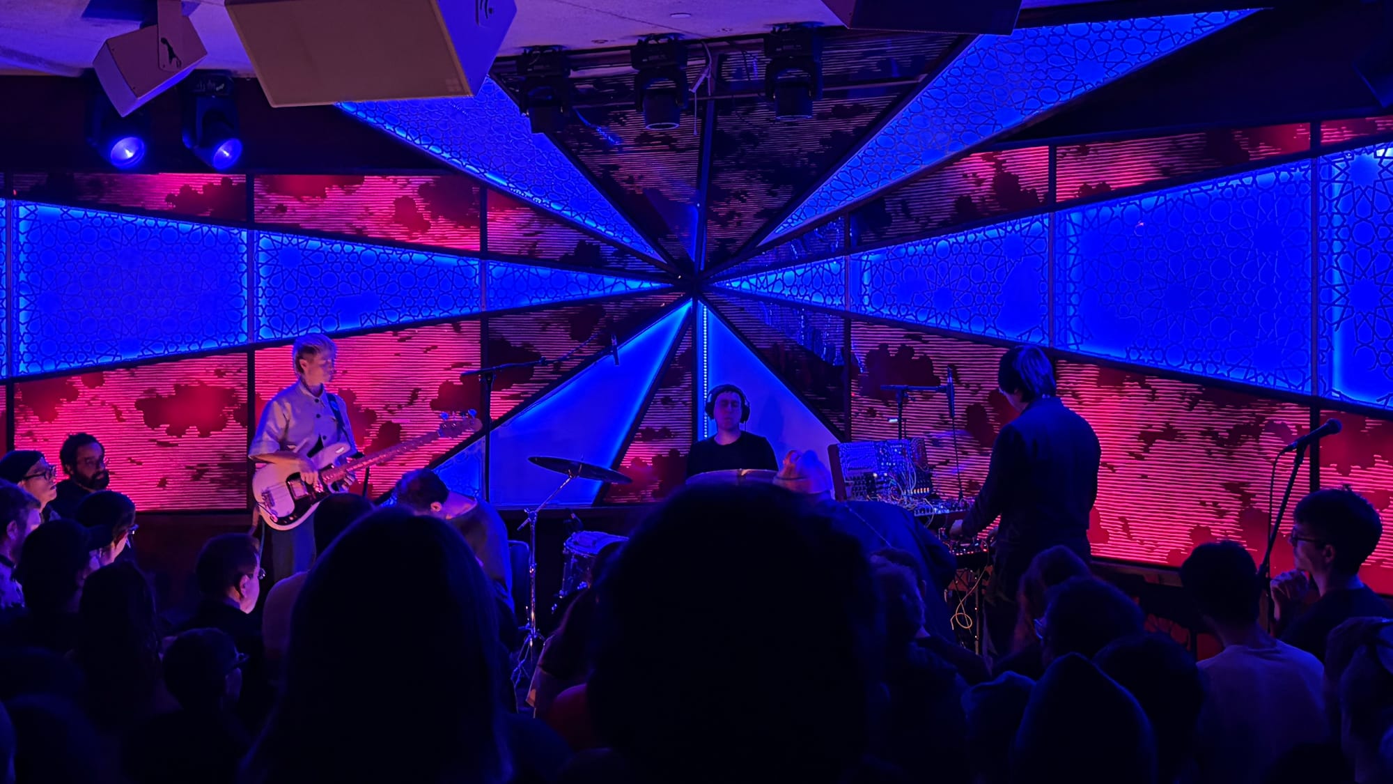 Jazz group SML performs live in front of a red and blue light show