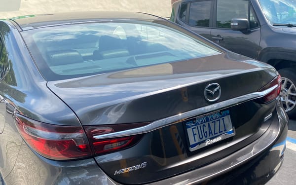 Sedan with the NY license plate "FUGAZZI"