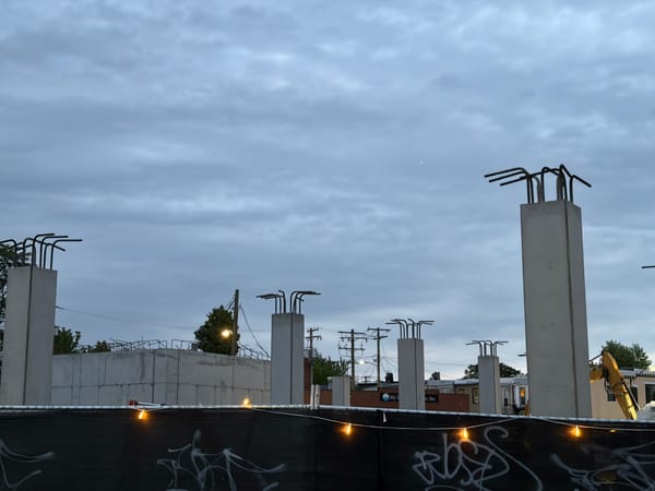 Construction site with pillars and bent rebar