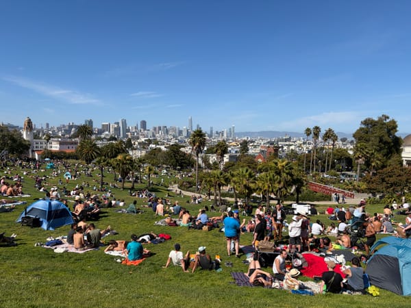 People enjoying a sunny day at Mission Delores Park